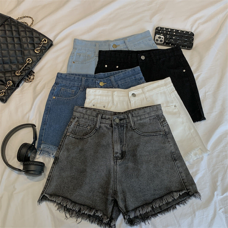 THE DISTRESSED HIGH-RISE DENIM SHORTS