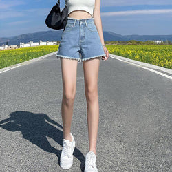 THE DISTRESSED HIGH-RISE DENIM SHORTS