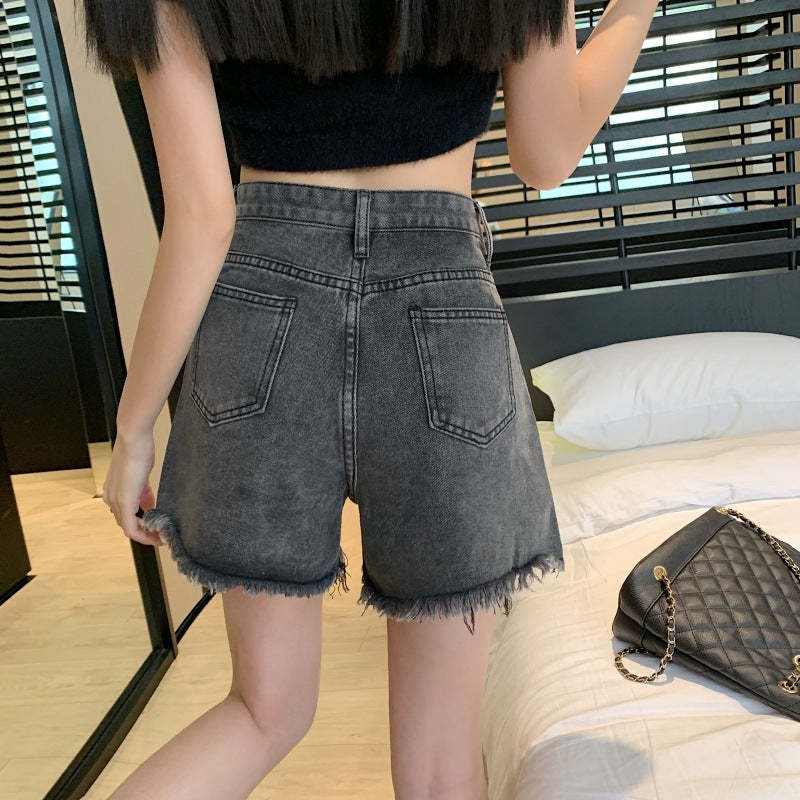 THE DISTRESSED HIGH-RISE DENIM SHORTS